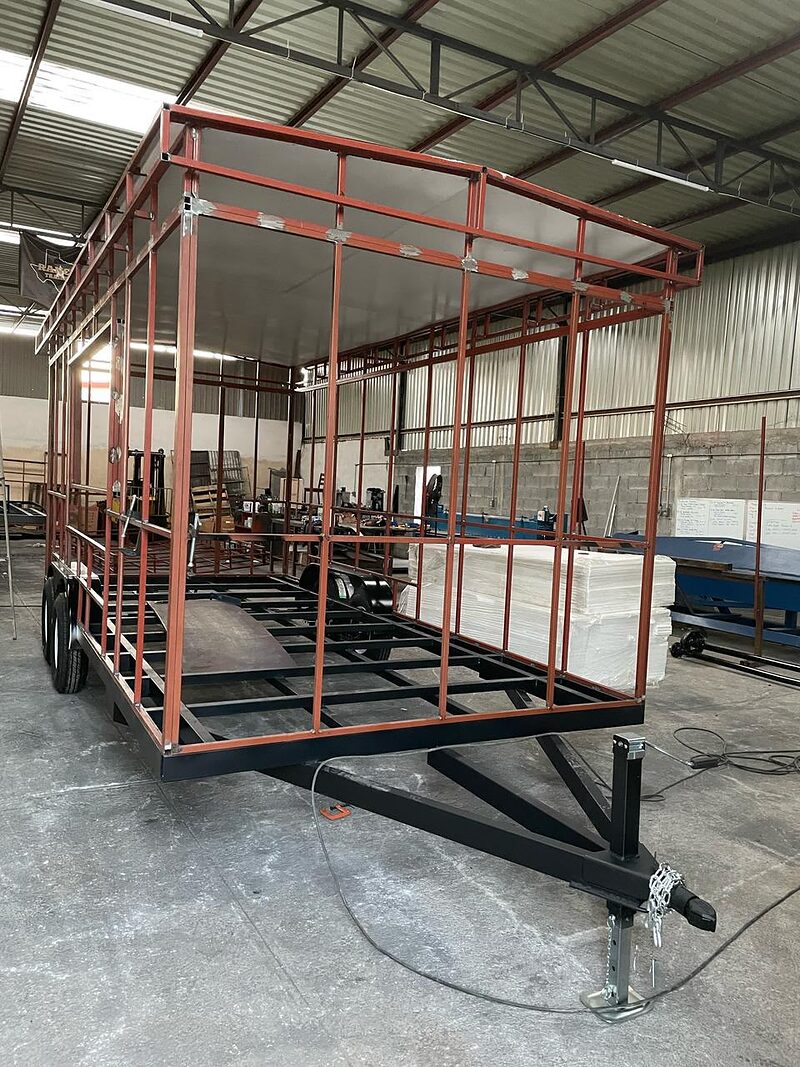 A trailer body framed up in the shop — one of the build stages we photograph and send you